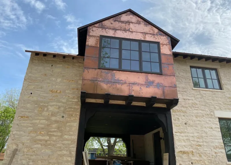 Copper metal panel facade on a stone building for Metal Roof Coating in Van Buren